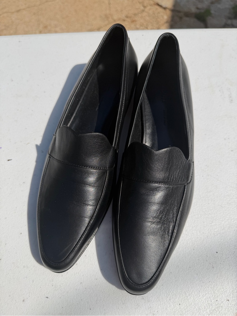 KHAITE Black Leather Scalloped Penny Loafers